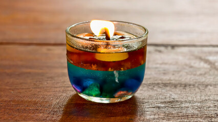 Candlelight creates an alluring, decorative accent featuring blue crystals and wooden background