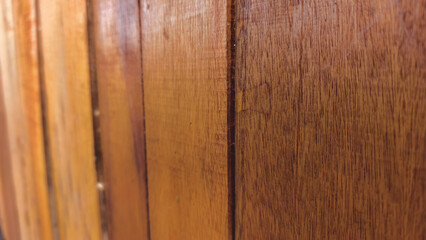 Naklejka premium Detailed close up of vertical brown wooden planks showing texture and grain in natural light