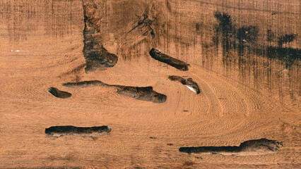 Detailed close up of damaged wooden plank with deep cracks and eroded texture