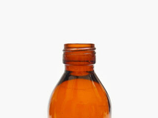 Open Amber glass bottle isolated on a white background, close up, brown glass bottle for pharmaceuticals, syrups, essential oils, and cosmetics