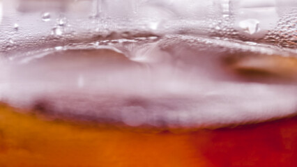 Macro view of condensation forming on a refreshing glass of iced tea