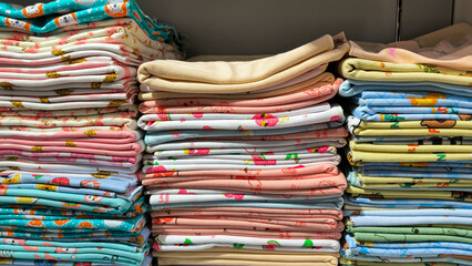 Stacks of baby cloths create an inviting textile shop atmosphere