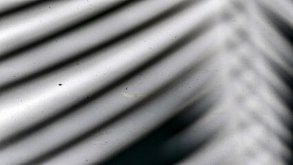 Subtle interplay of light and shadow casting organic lines across a textured surface