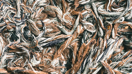 Textural tapestry of woven threads and fibers a dynamic blend of earthy browns grays and soft