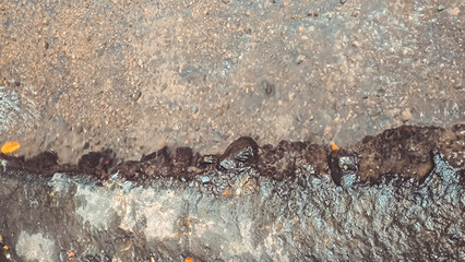 Textured abstraction: Water flowing through the rugged terrains of the concrete surfacescape