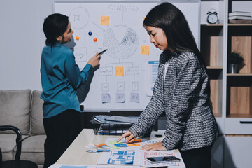 Group of young application developers analyzing uxui mobile app templates during a working meeting