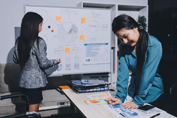Group of young application developers analyzing uxui mobile app templates during a working meeting