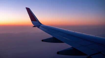 Obraz premium Scenic sunset view from airplane wing over clouds