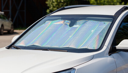 A car with a sun visor on the windshield