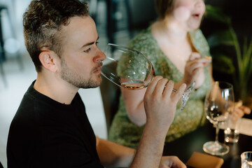 Sommelier tasting rose wine during professional winetasting session