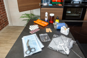 Medical supplies on kitchen table, including daily medication, medicines, insulin injection, pills,...
