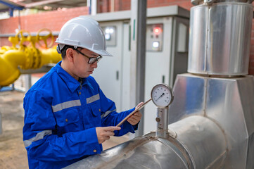 Engineer Overseeing Industrial Cooling System,Factory Technician Performing Machine...