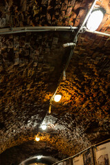 a burning lamp in a brick basement
