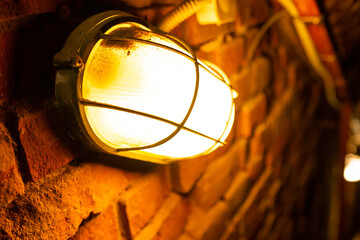 a burning lamp in a brick basement
