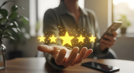 Person holding glowing five-star rating above hand, symbolizing top satisfaction and positive review achievement.