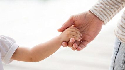 Close-Up of Parent and Child Hands Holding Each Other Outdoors