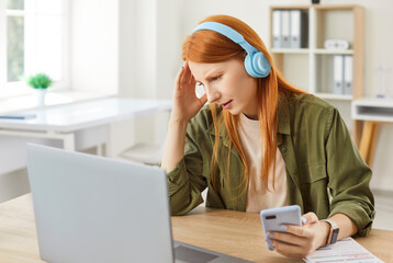 Distressed woman at home working or learning online, showing concern after receiving bad news on...