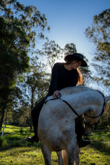 woman riding horse and turning head to the side