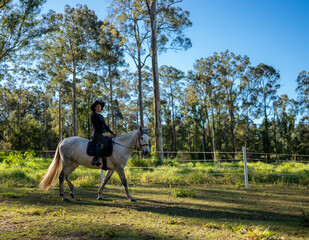 A woman riding a horse