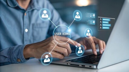 Person interacting with digital user icons and data charts on a laptop screen