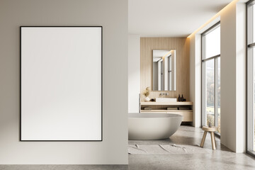 Minimalist interior bathroom with large blank framed poster mockup on wall and modern bathtub near...
