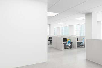 Modern open space office with minimalistic cubicle layout, blue chairs, and bright daylight through...