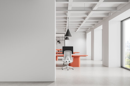 Modern office interior with blank white wall and coral desks for poster or design mockup presentation in clean minimal workspace environment. 3D Rendering
