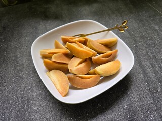 Slice of sapodilla fruit on a plate