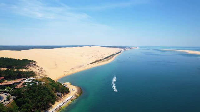 Aerial view of the Dune of Pilat, the highest sand dune in Europe, located in La Teste-de-Buch in Arcachon Bay, France, southwest of Bordeaux, along the Atlantic coast of France on a sunny day