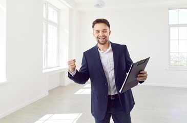Happy realtor, sale agent euphoric about success, reward promotion, celebrating work achievement in...