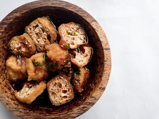 Tahu Gejrot (Indonesian food) consists of tofu that has been fried and then cut into small pieces and then eaten with a sauce with chili, garlic, shallots, sugar. Usually served in small
