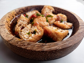 Tahu Gejrot (Indonesian food) consists of tofu that has been fried and then cut into small pieces and then eaten with a sauce with chili, garlic, shallots, sugar. Usually served in small