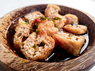 Tahu Gejrot (Indonesian food) consists of tofu that has been fried and then cut into small pieces and then eaten with a sauce with chili, garlic, shallots, sugar. Usually served in small
