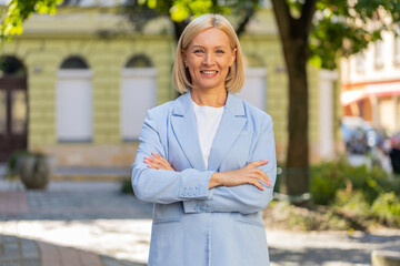 Confident smiling Caucasian mature woman blonde businesswoman employee in formal suit looking at...