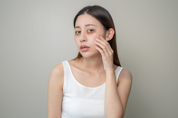 Bored, insomnia asian young woman, girl looking at mirror hand touching under eyes with problem of...