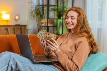 Planning budget. Rich happy young woman counting money euro cash using laptop calculate domestic...