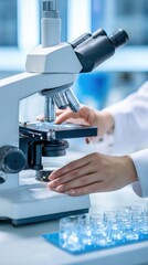 modern lab environment, close up of hands adjusting microscope, white coat sleeves, glass slides on table, clinical lighting, soft blue highlights