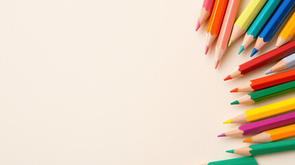 Fototapeta premium Colorful pencils arranged on light background create vibrant and artistic atmosphere, perfect for creativity
