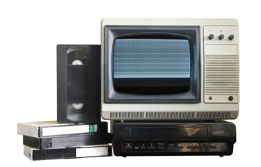 Old vintage TV with static on screen and VCR and video cassettes isolated on white background.