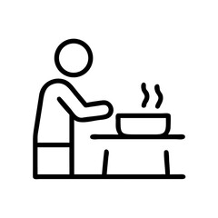 Person cooking at kitchen table with steaming pot  
