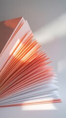 Fanned pages of a book with orange and white paper