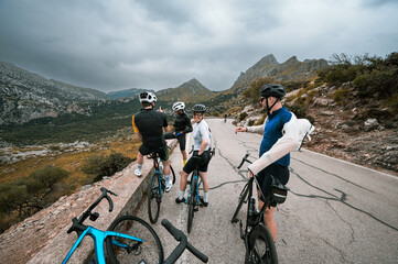 Road cyclists take a break and put on warm clothes