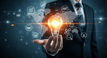 Naklejka premium Glowing light bulb held by businessman with global network