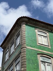 Historic Green Tiled Building Corner under Blue Sky