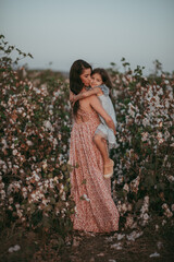 mother and daughter on the field of cotton