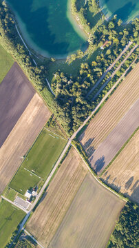 Aerial view over Feringasee, a beautiful lake with green fields in Munich, Germany