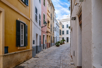 Colorful Historic Street With Traditional Shutters And Cobblestone Pavement In Ciutadella Menorca Spain. Old Town Architecture, Mediterranean Buildings, Narrow Alley, Balearic Heritage