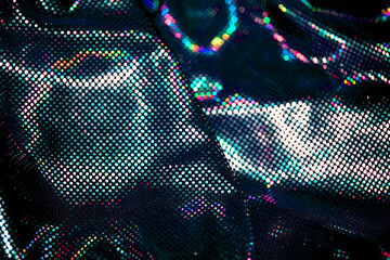 Holographic shiny spots and dots bokeh on fabric for a futuristic disco background