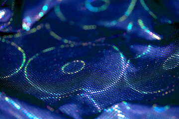 Holographic shiny spots and dots bokeh on fabric for a futuristic disco background