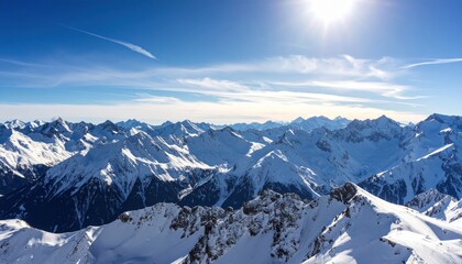 Breathtaking aerial view of snowy mountain peaks under a clear blue sky, showcasing nature's grandeur and serenity.